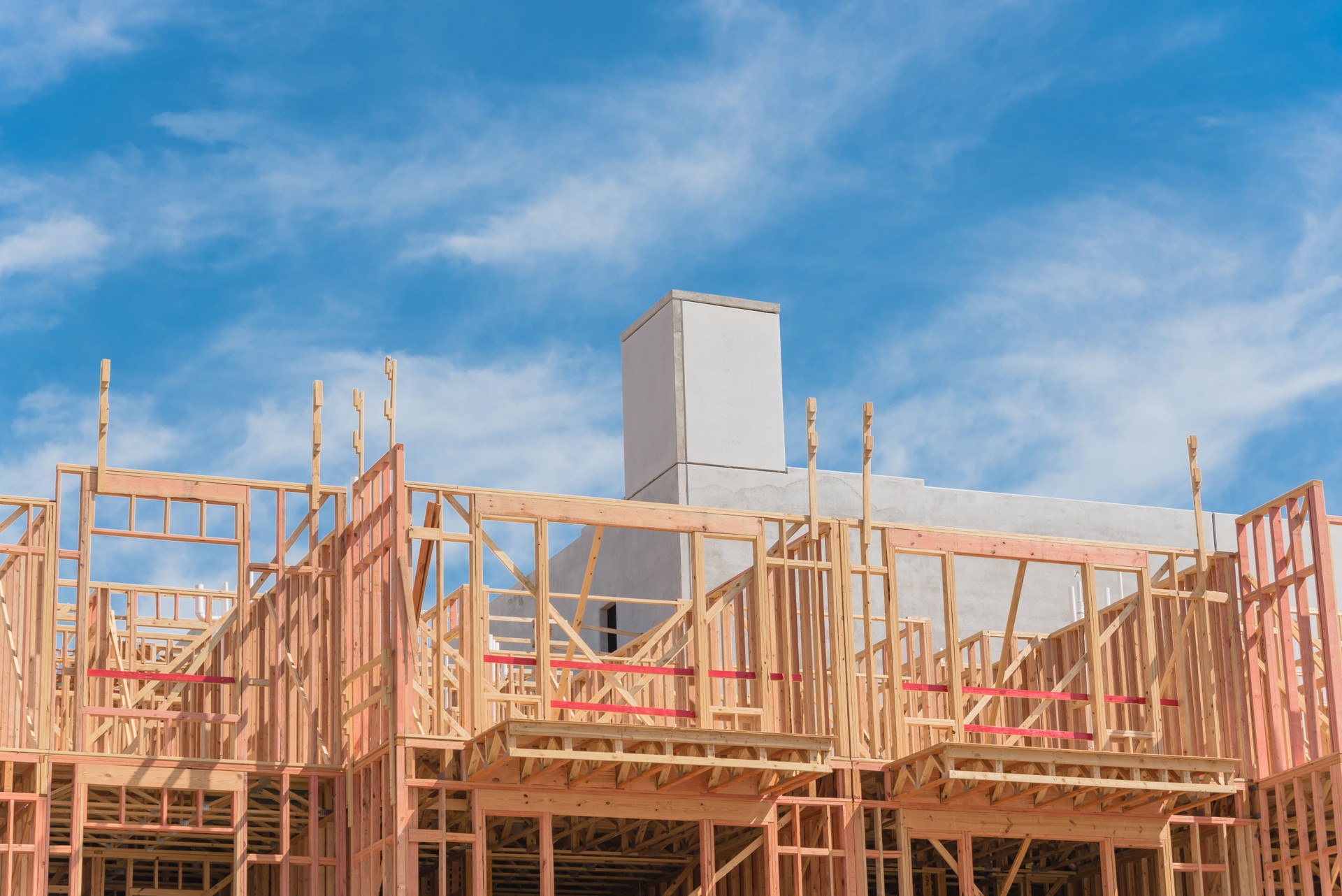 Podium construction of urban apartment complex with above-grade multi-story parking garage in Dallas, Texas, USA